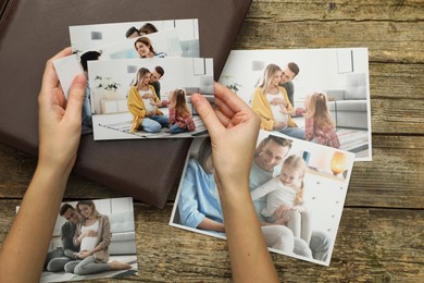 Photo of Woman with different photos and photo album at wooden table, top view