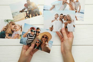 Photo of Woman with different photos at white wooden table, top view