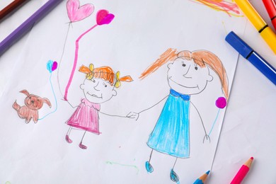 Photo of Child's drawing of happy family and supplies as background, top view