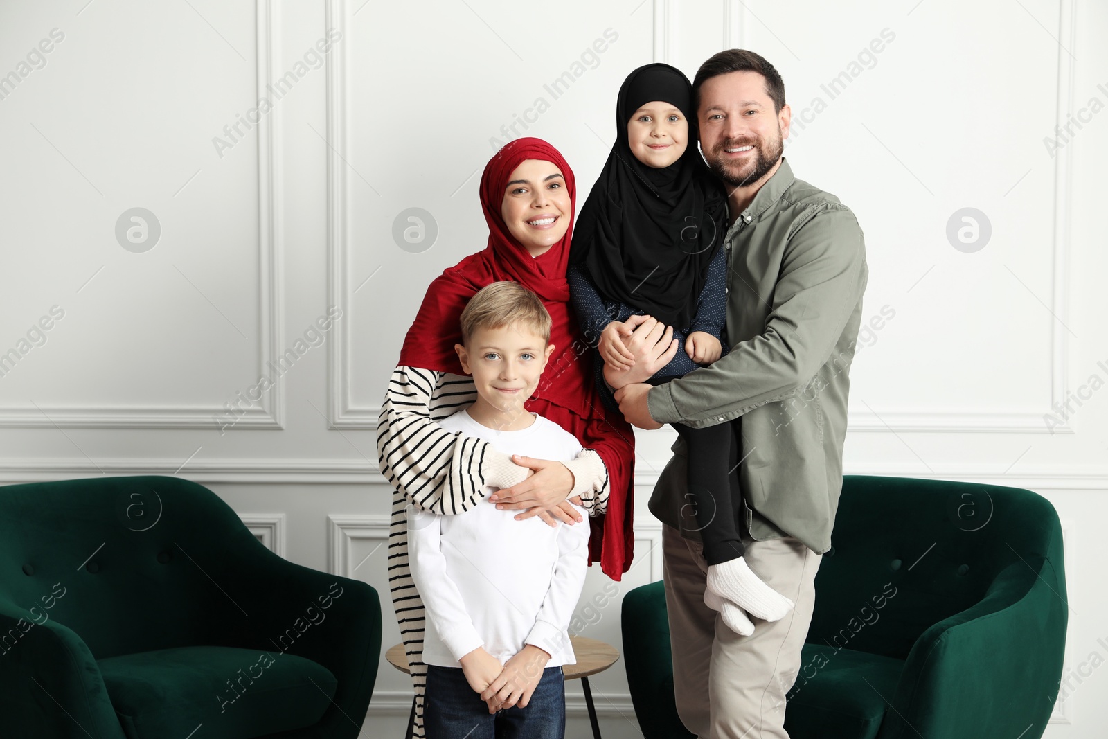 Photo of Happy Muslim family spending time together at home