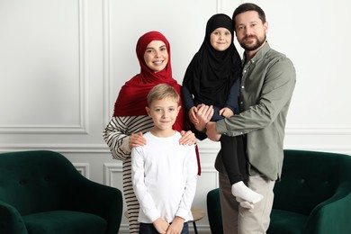 Photo of Happy Muslim family spending time together at home