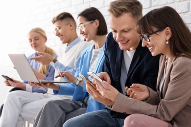 Photo of Group of people using different gadgets indoors. Modern technology