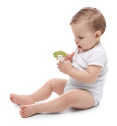 Photo of Cute little baby with toy on white background