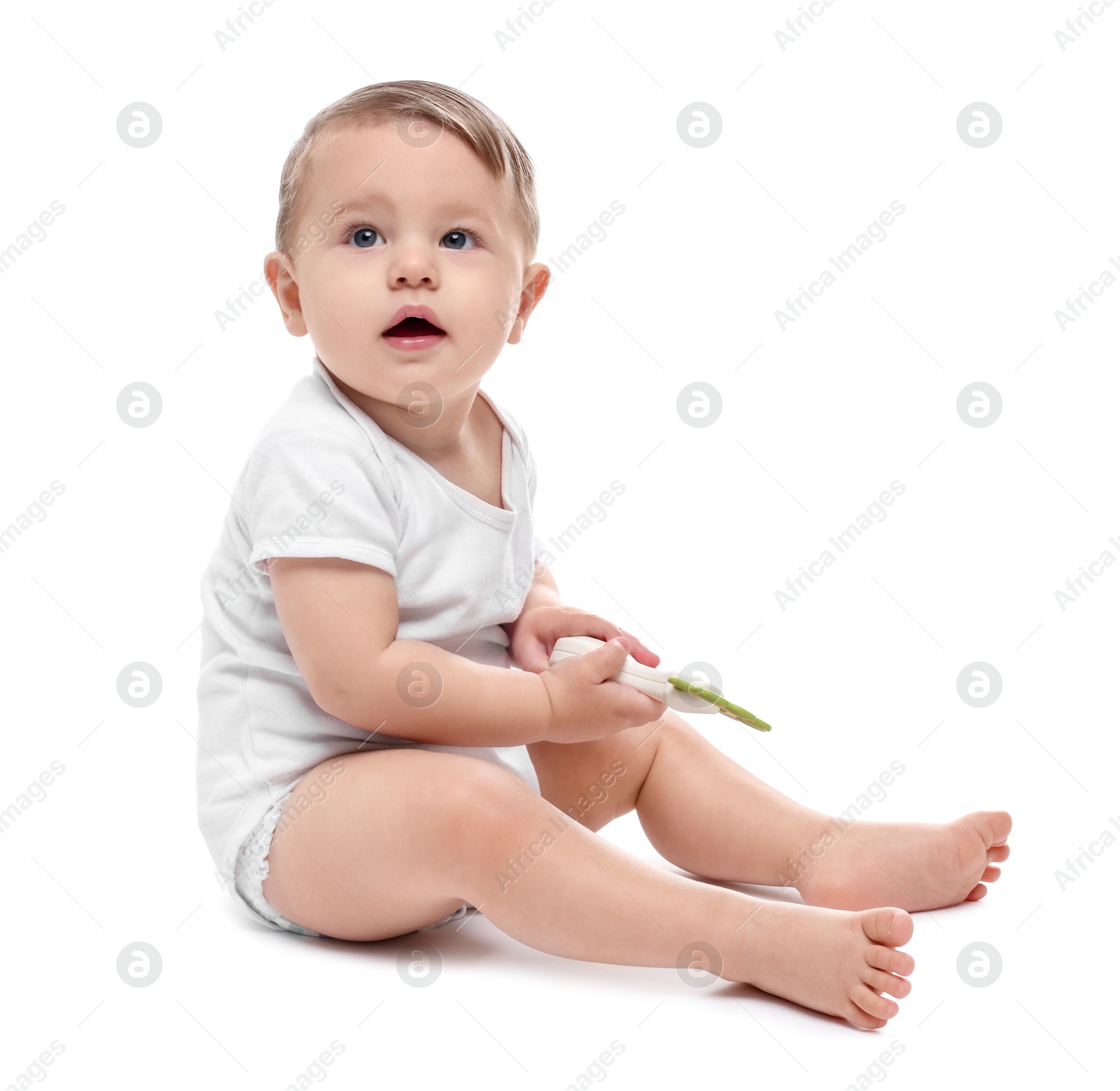 Photo of Cute little baby with toy on white background