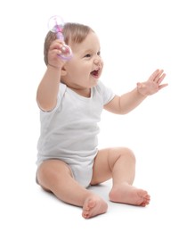 Photo of Cute little baby with toy on white background