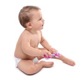 Photo of Cute little baby in diaper with toy on white background