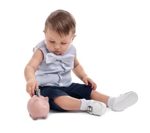 Photo of Little baby with money and piggybank on white background