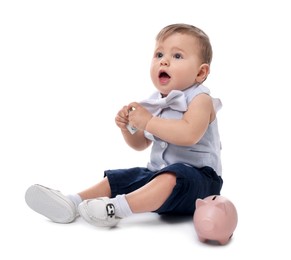 Photo of Little baby with money and piggybank on white background