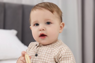 Photo of Adorable little baby with toy at home