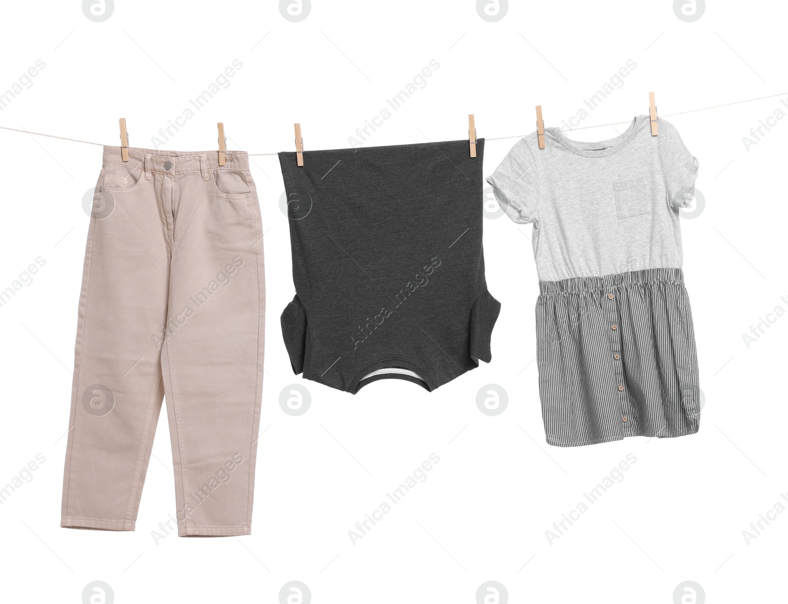 Photo of Different clothes drying on laundry line against white background