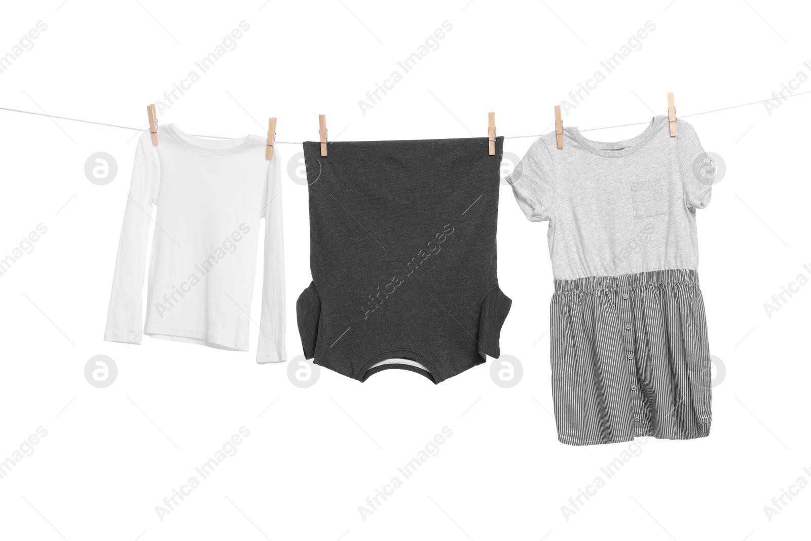 Photo of Different clothes drying on laundry line against white background