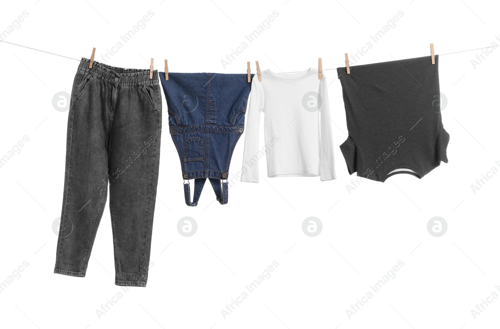 Photo of Different clothes drying on laundry line against white background