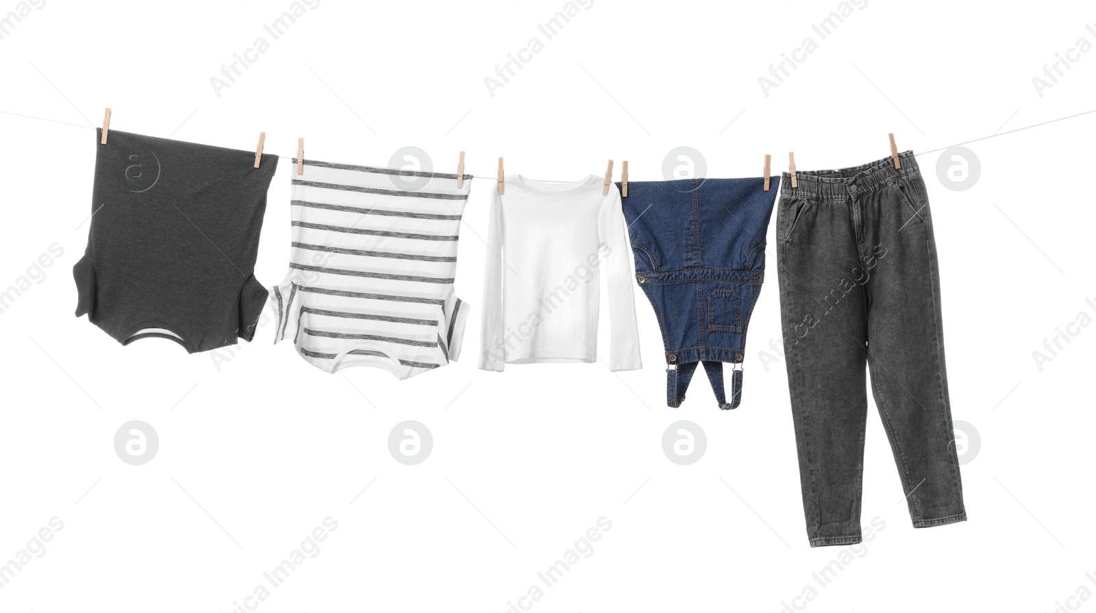 Photo of Different clothes drying on laundry line against white background