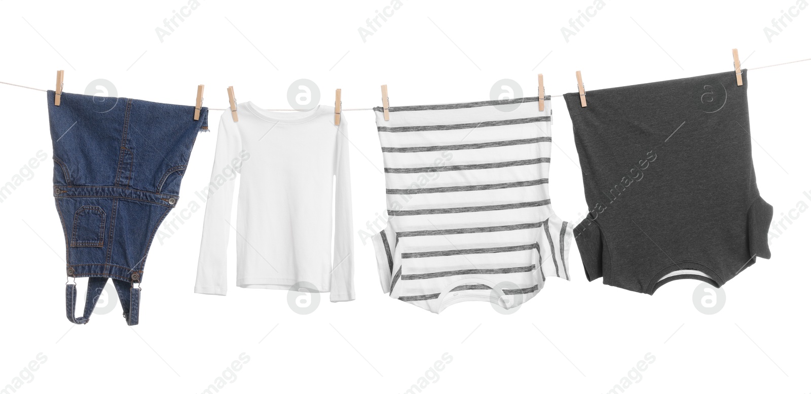 Photo of Different clothes drying on laundry line against white background