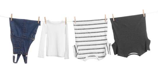 Photo of Different clothes drying on laundry line against white background