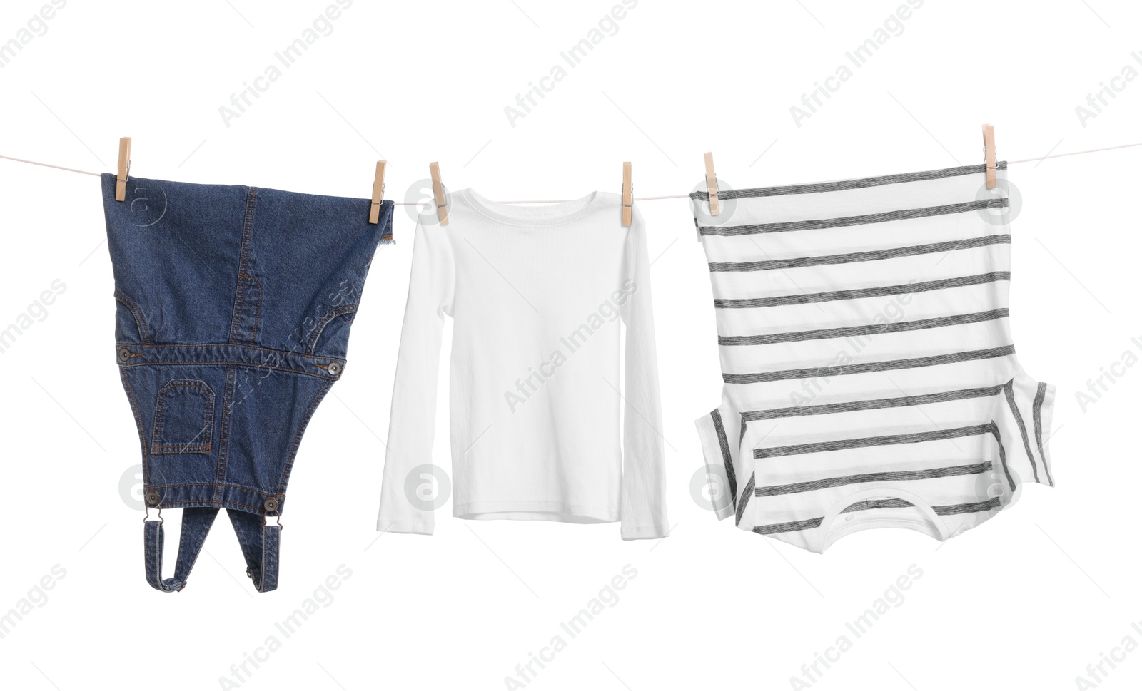 Photo of Different clothes drying on laundry line against white background