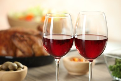 Photo of Red wine and delicious dinner served on table, closeup. Space for text