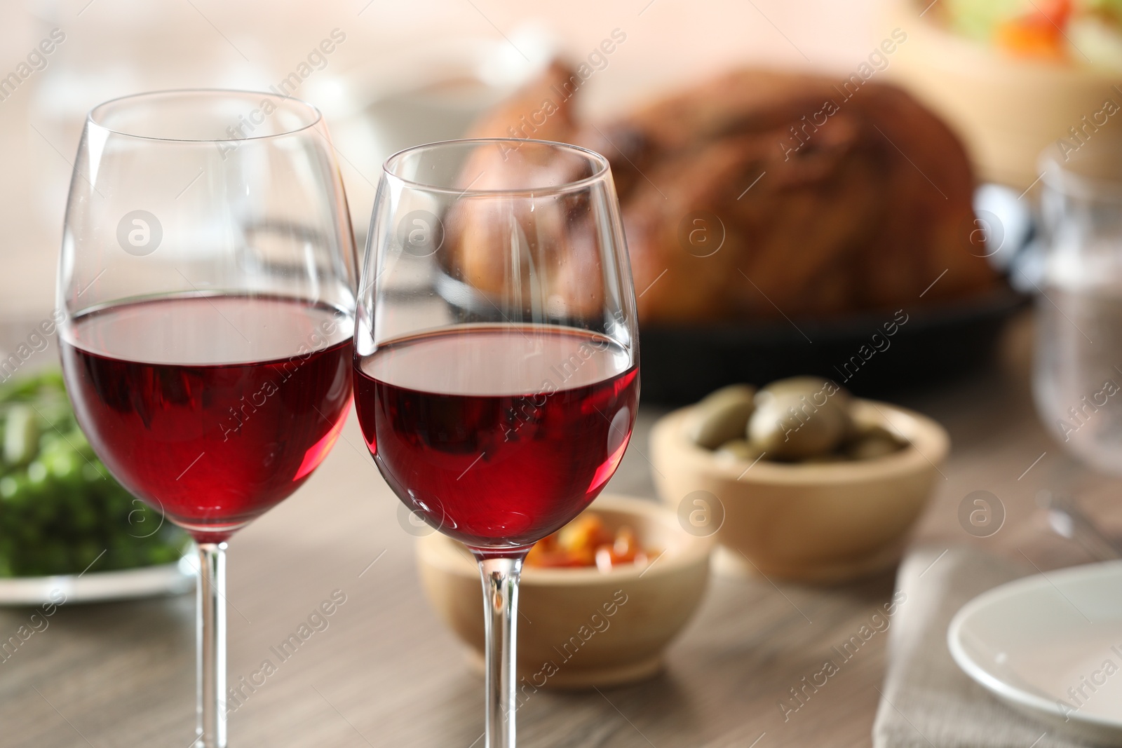 Photo of Red wine and delicious dinner served on table, closeup. Space for text