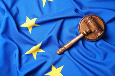 Photo of Judge's gavel on flag of European Union, top view. Space for text