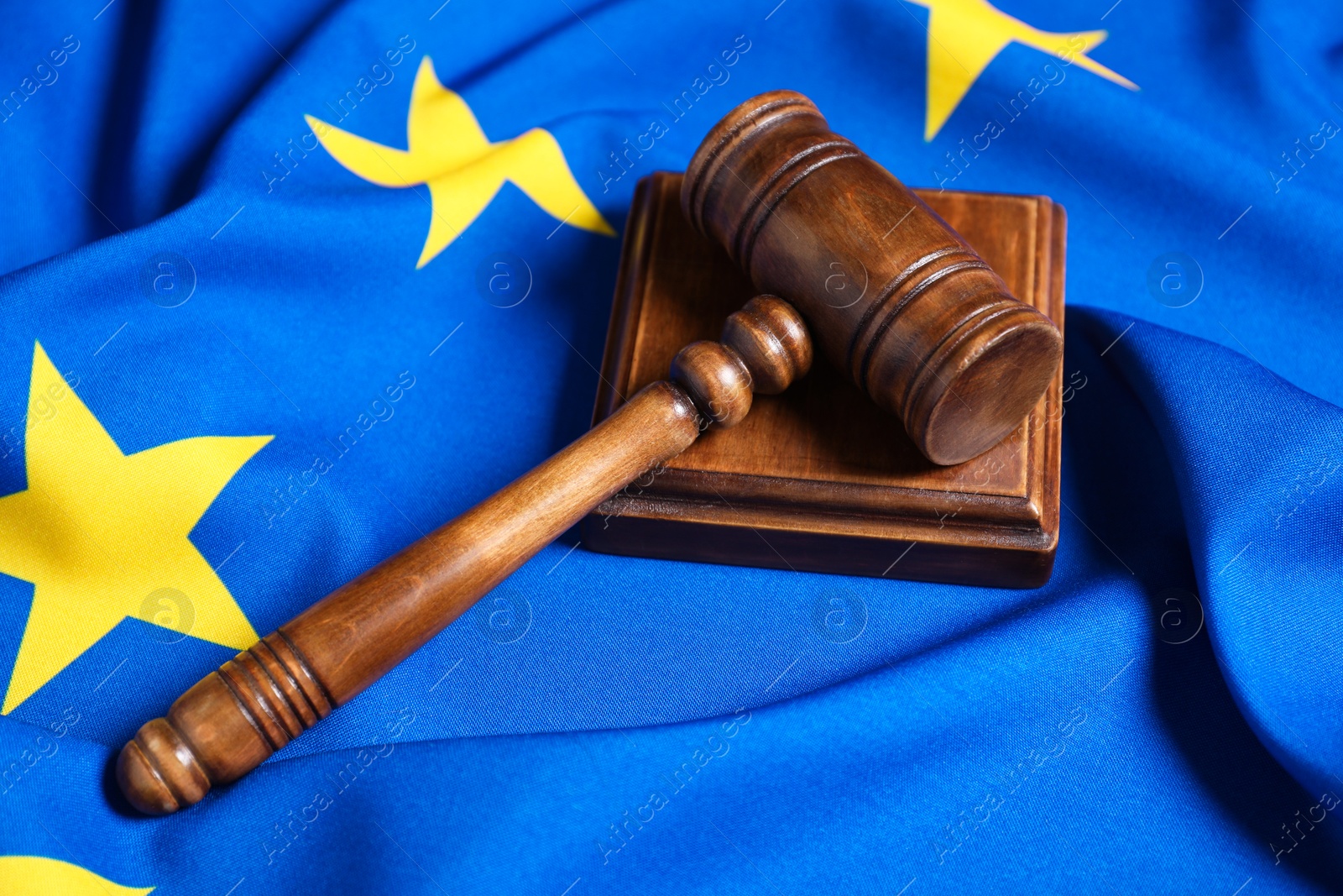 Photo of Judge's gavel on flag of European Union, closeup