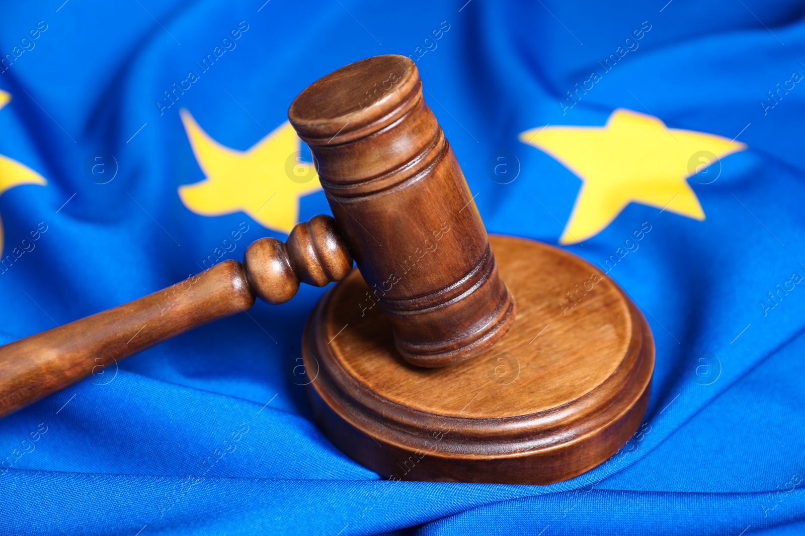 Photo of Judge's gavel on flag of European Union, closeup