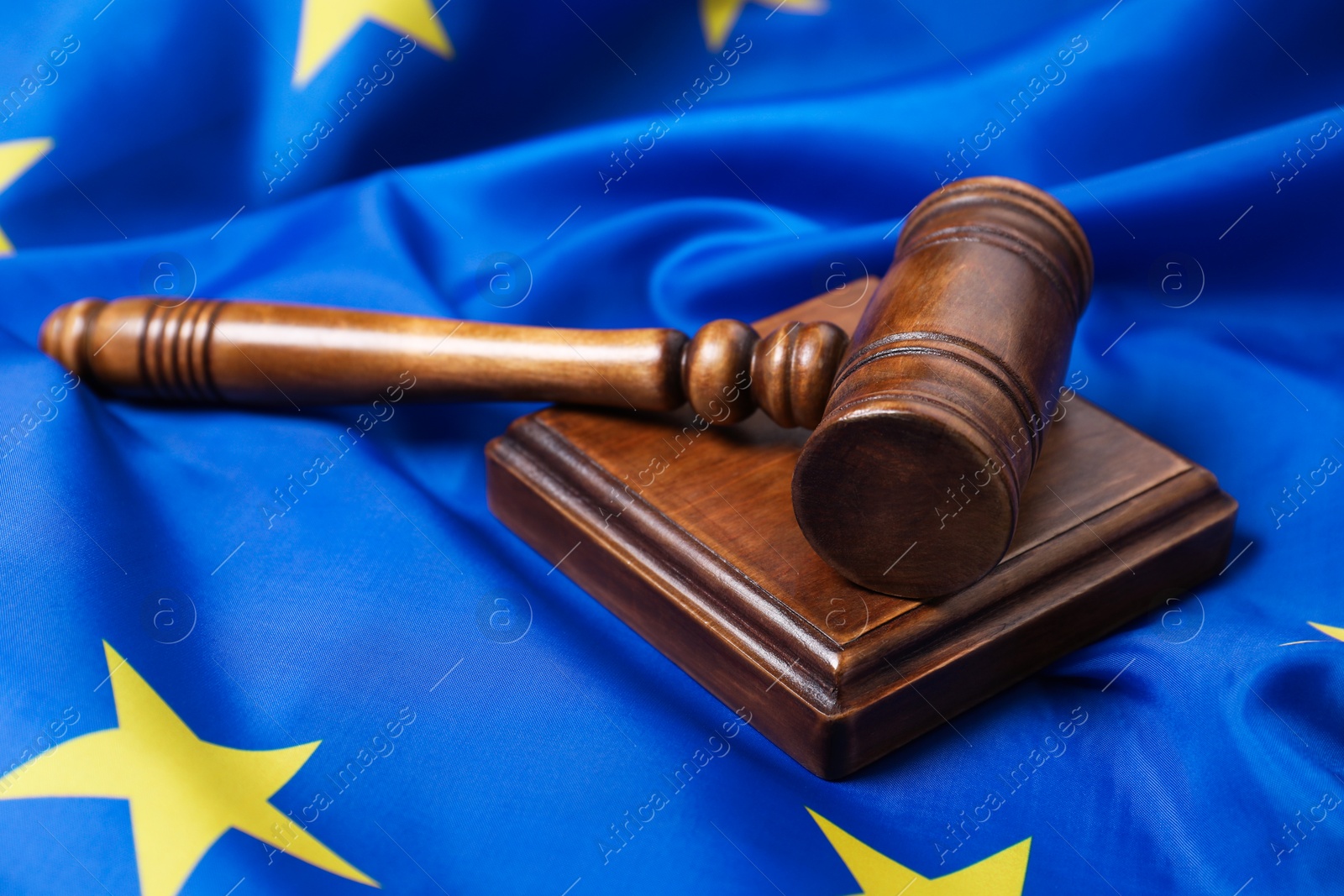 Photo of Judge's gavel on flag of European Union, closeup