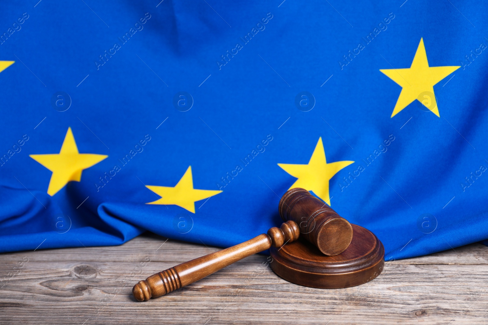 Photo of Judge's gavel and European Union flag on wooden table