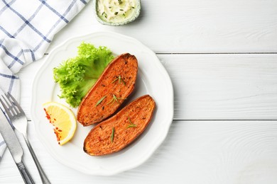 Photo of Tasty baked sweet potato served on white wooden table, flat lay. Space for text