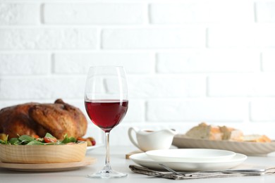 Photo of Red wine and delicious dinner served on light table