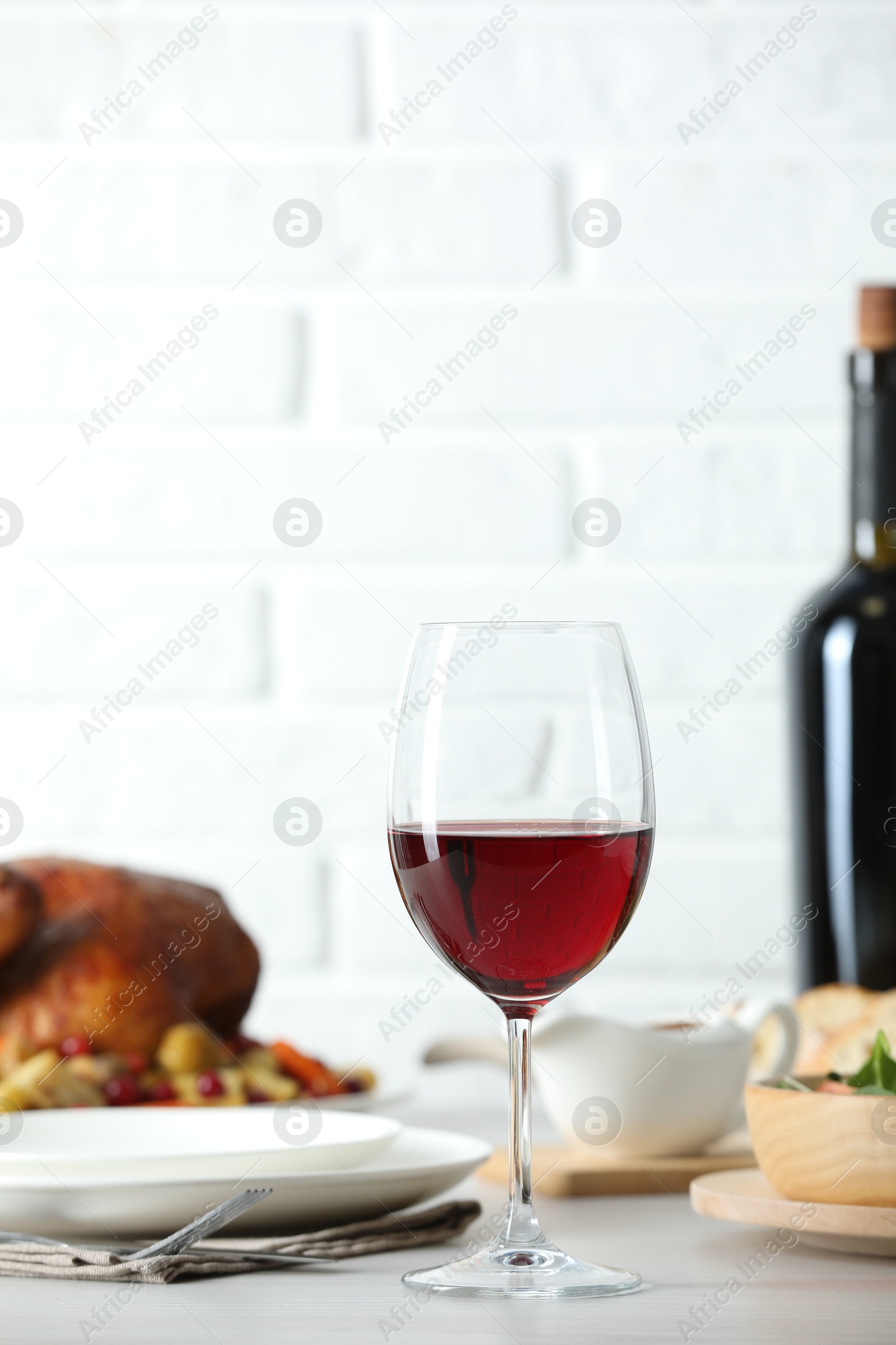 Photo of Red wine and delicious dinner served on light table