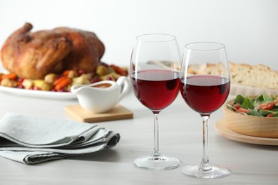 Photo of Red wine and delicious dinner served on light table