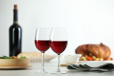 Photo of Red wine and delicious dinner served on light table