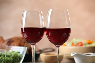 Photo of Red wine and delicious dinner served on table, closeup