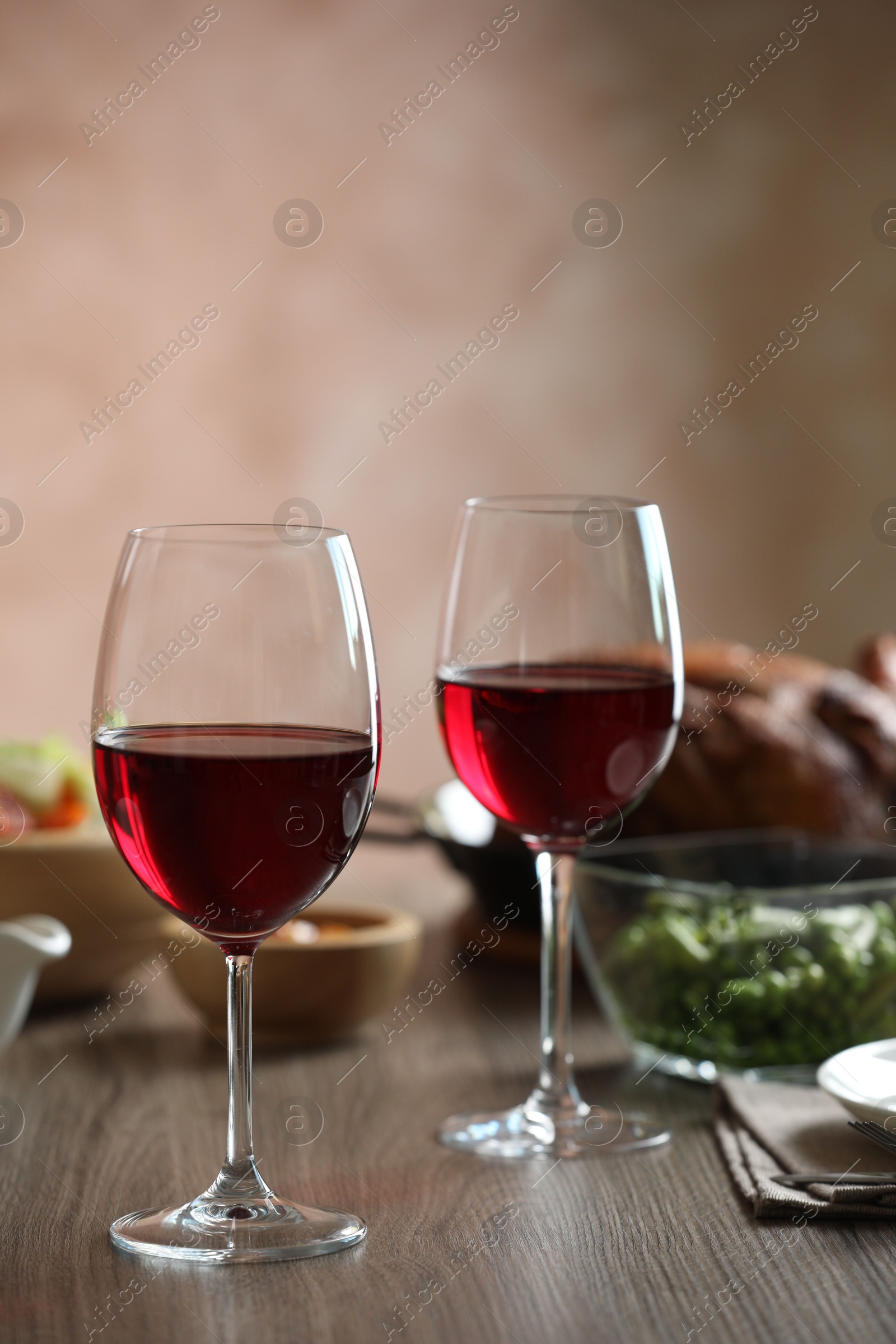 Photo of Red wine and delicious dinner served on wooden table