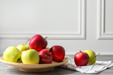 Photo of Fresh red and green apples on grey table