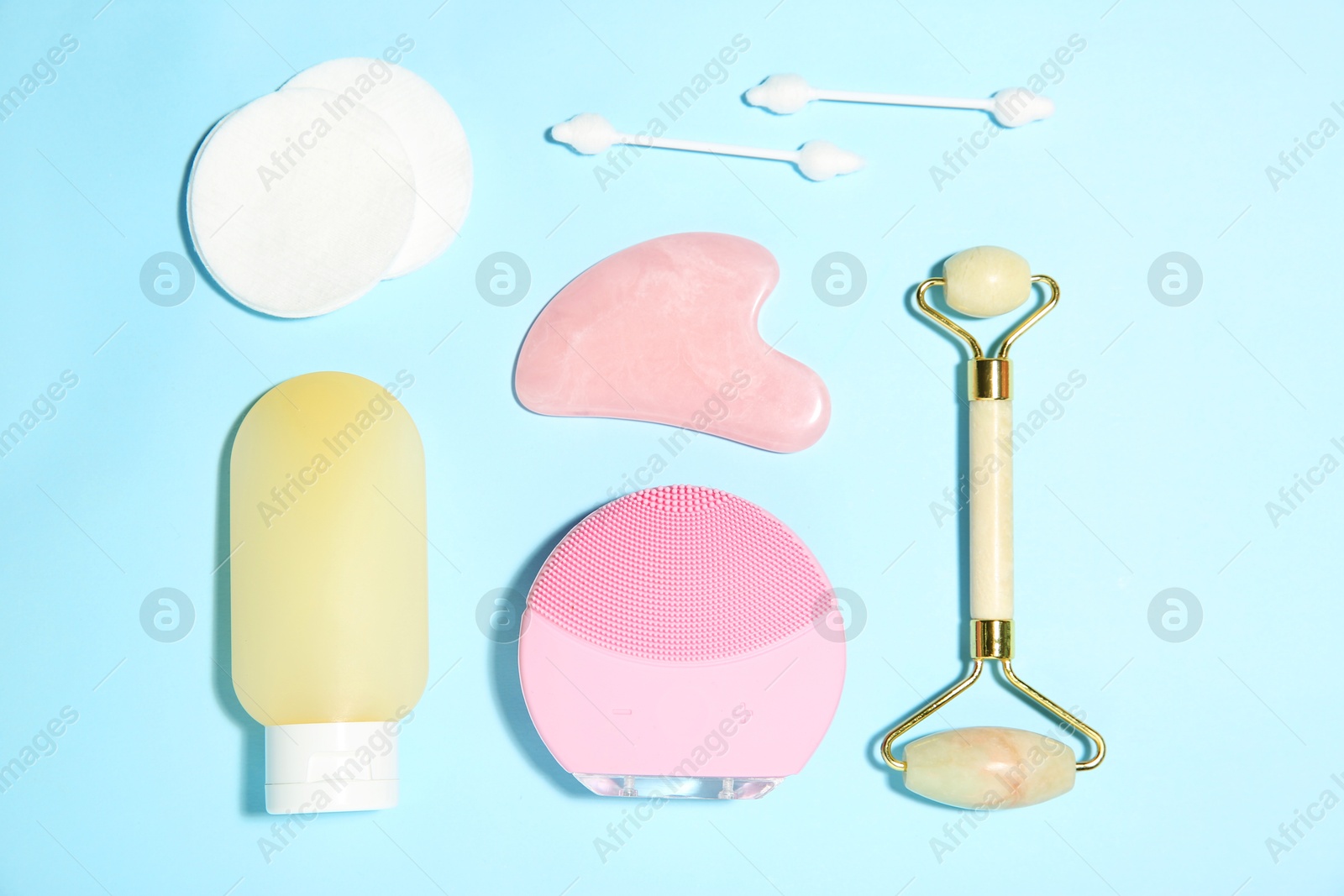 Photo of Different skin care products on light blue background, flat lay