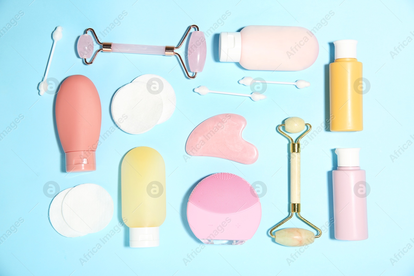 Photo of Different skin care products on light blue background, flat lay