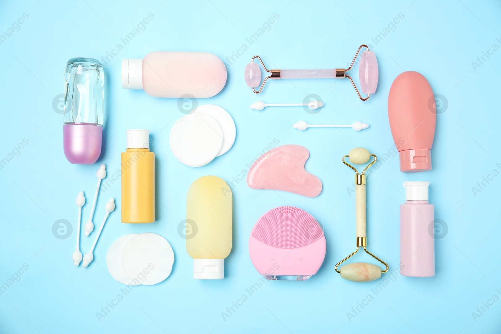 Photo of Different body care products on light blue background, flat lay