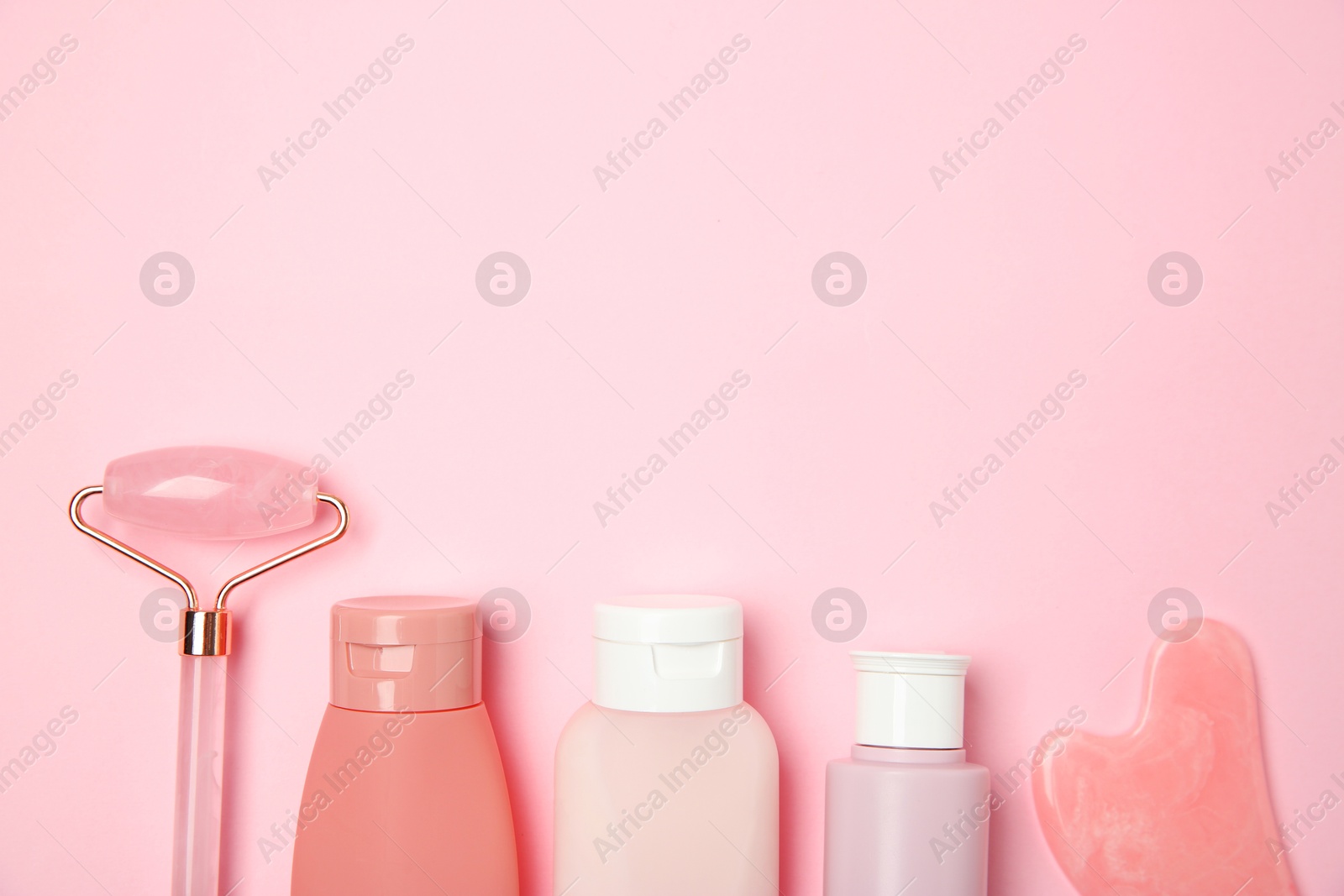 Photo of Different skin care products on pink background, flat lay. Space for text