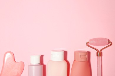 Photo of Different skin care products on pink background, flat lay. Space for text