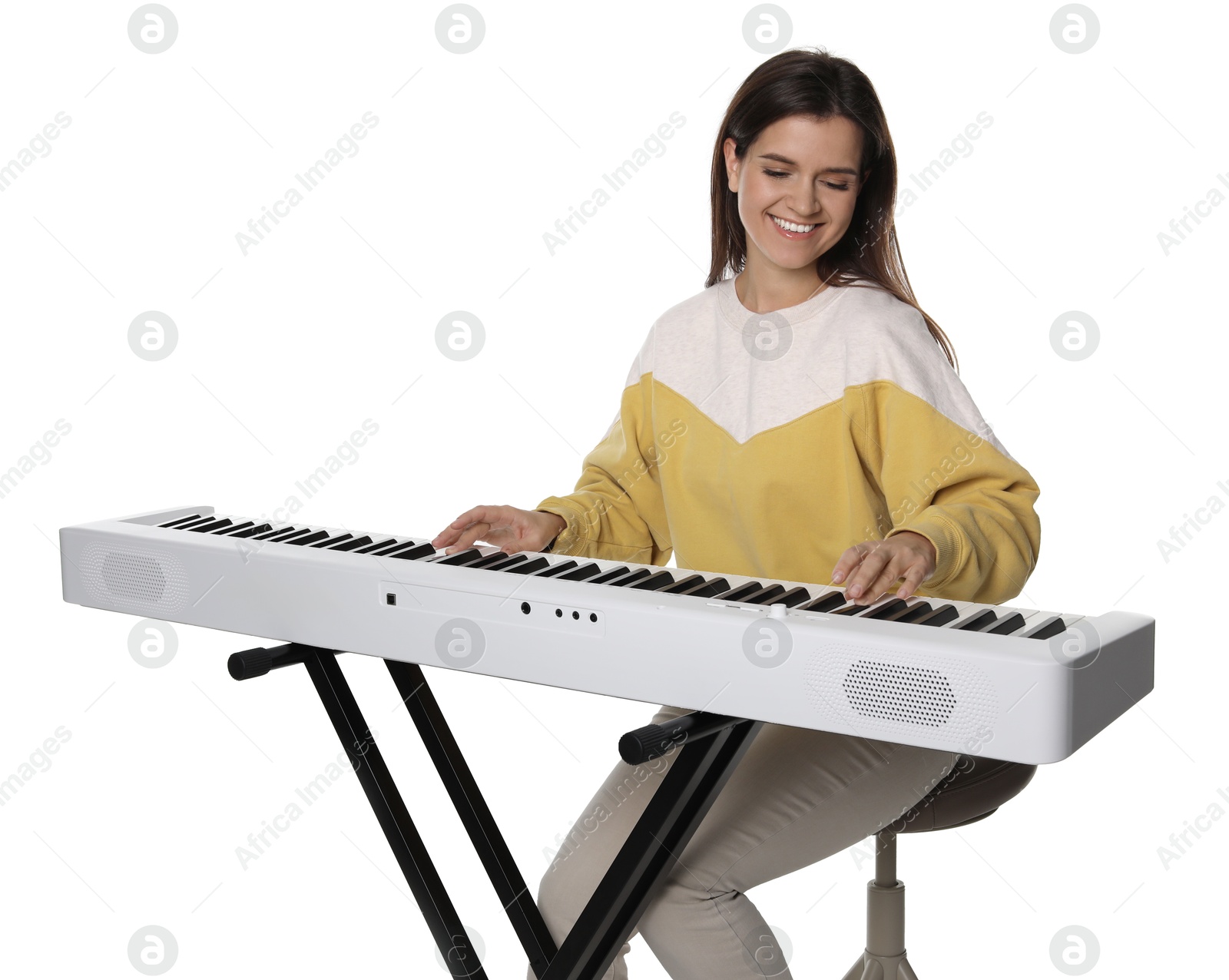 Photo of Smiling woman playing synthesizer on white background