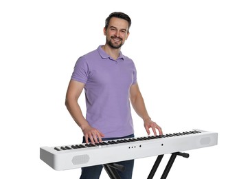 Photo of Smiling man playing synthesizer on white background