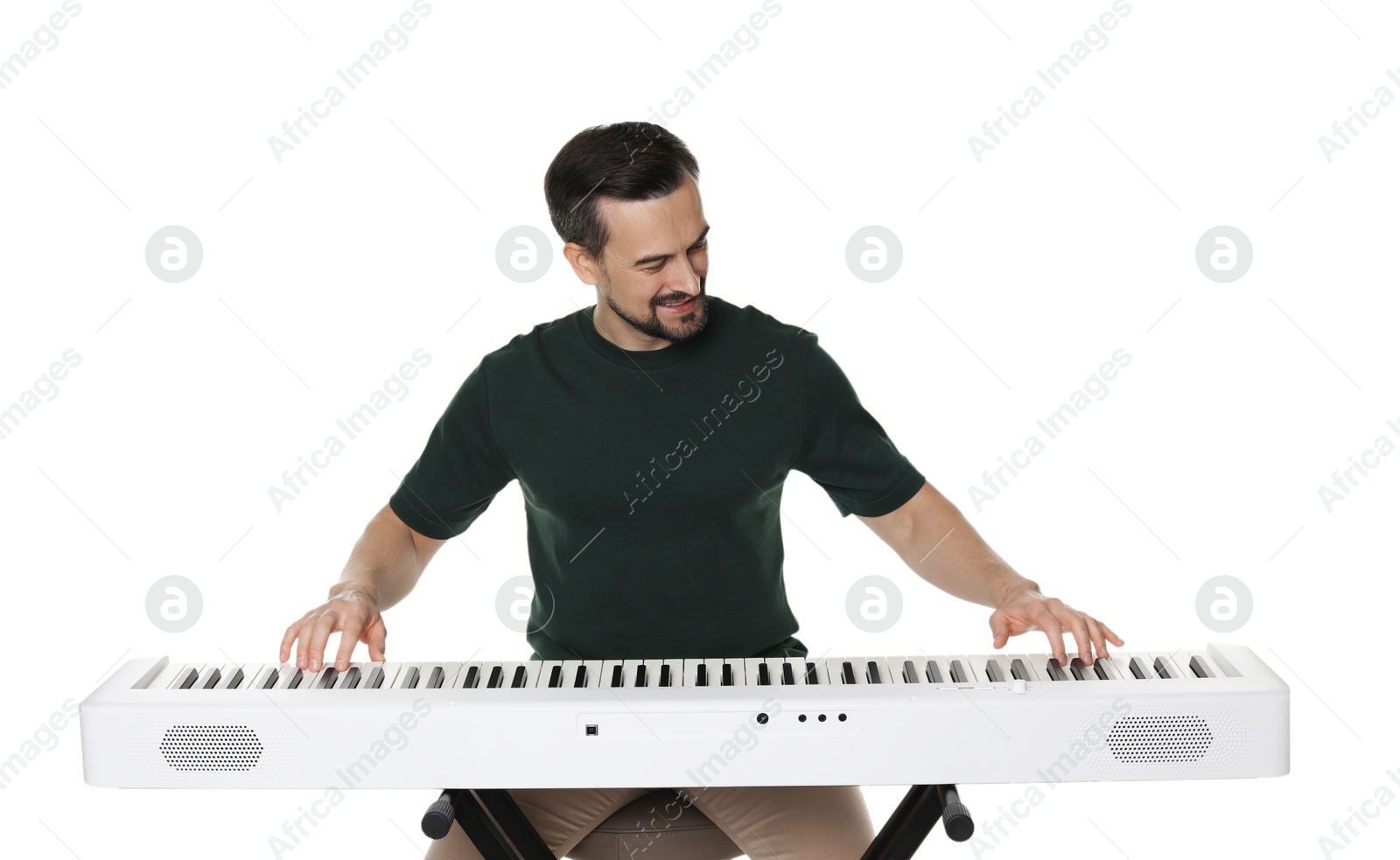 Photo of Bearded man playing synthesizer on white background