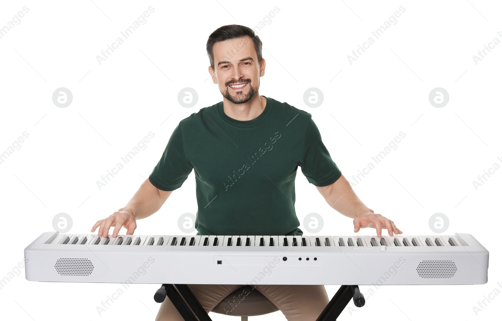 Photo of Smiling man playing synthesizer on white background