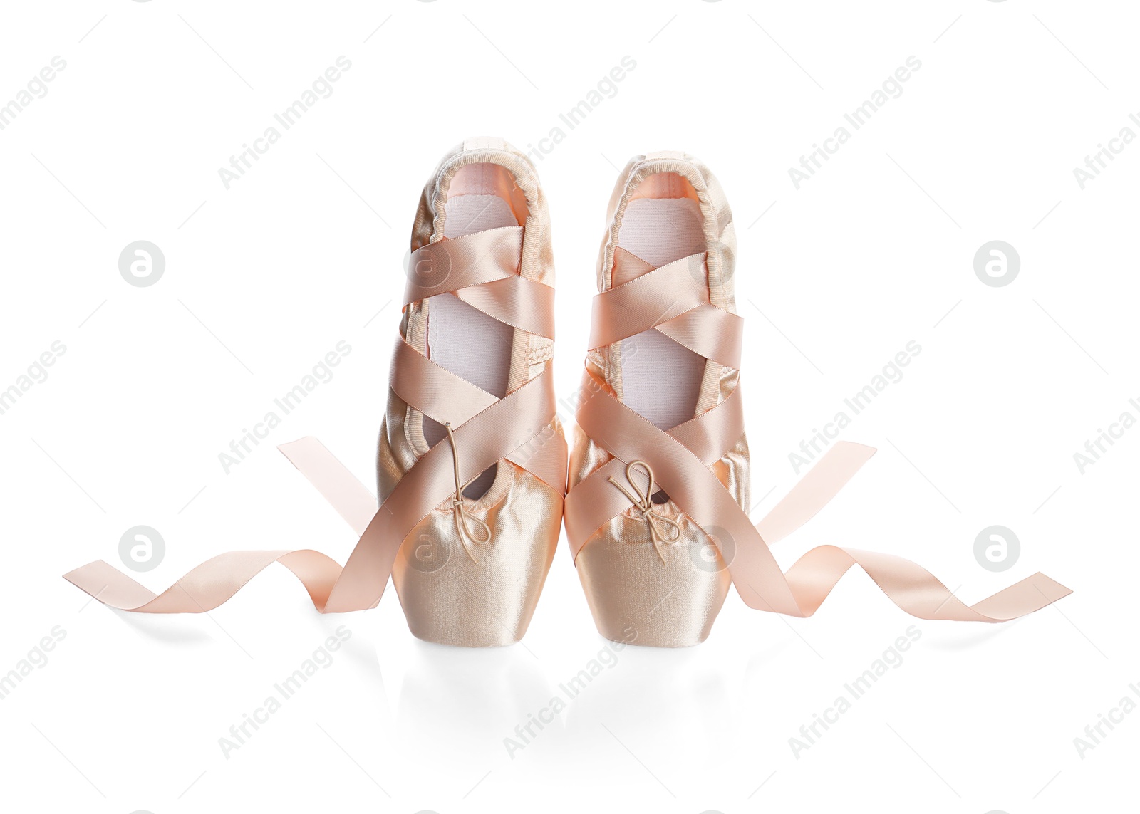 Photo of Pair of beautiful beige pointe shoes isolated on white