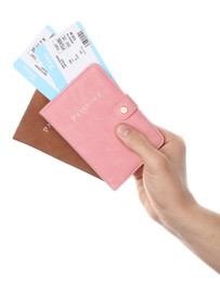 Photo of Travel agency. Man holding passports with flight tickets on white background, closeup