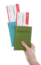 Photo of Travel agency. Woman holding flight tickets and passports on white background, closeup