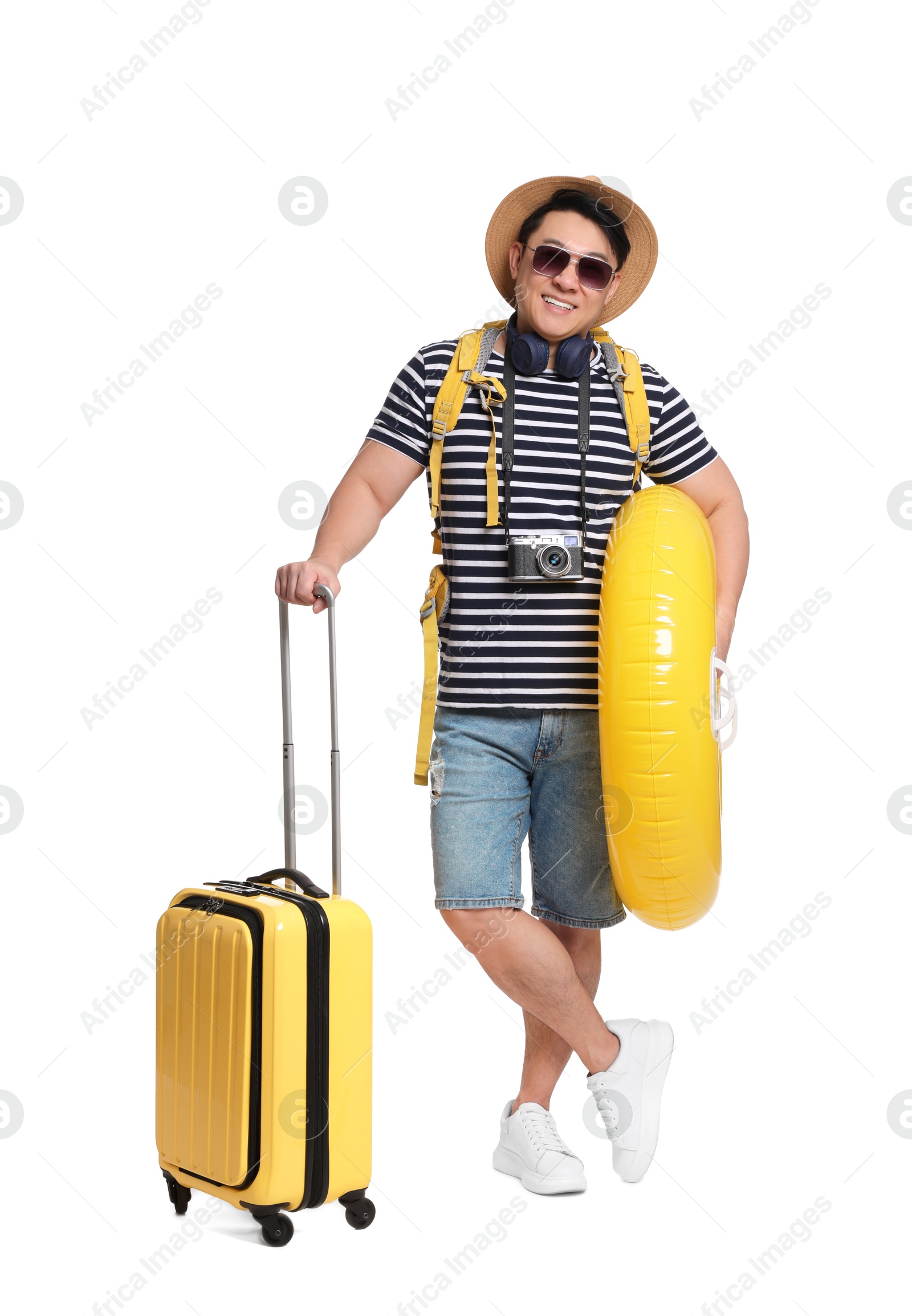 Photo of Traveller with suitcase and inflatable ring on white background