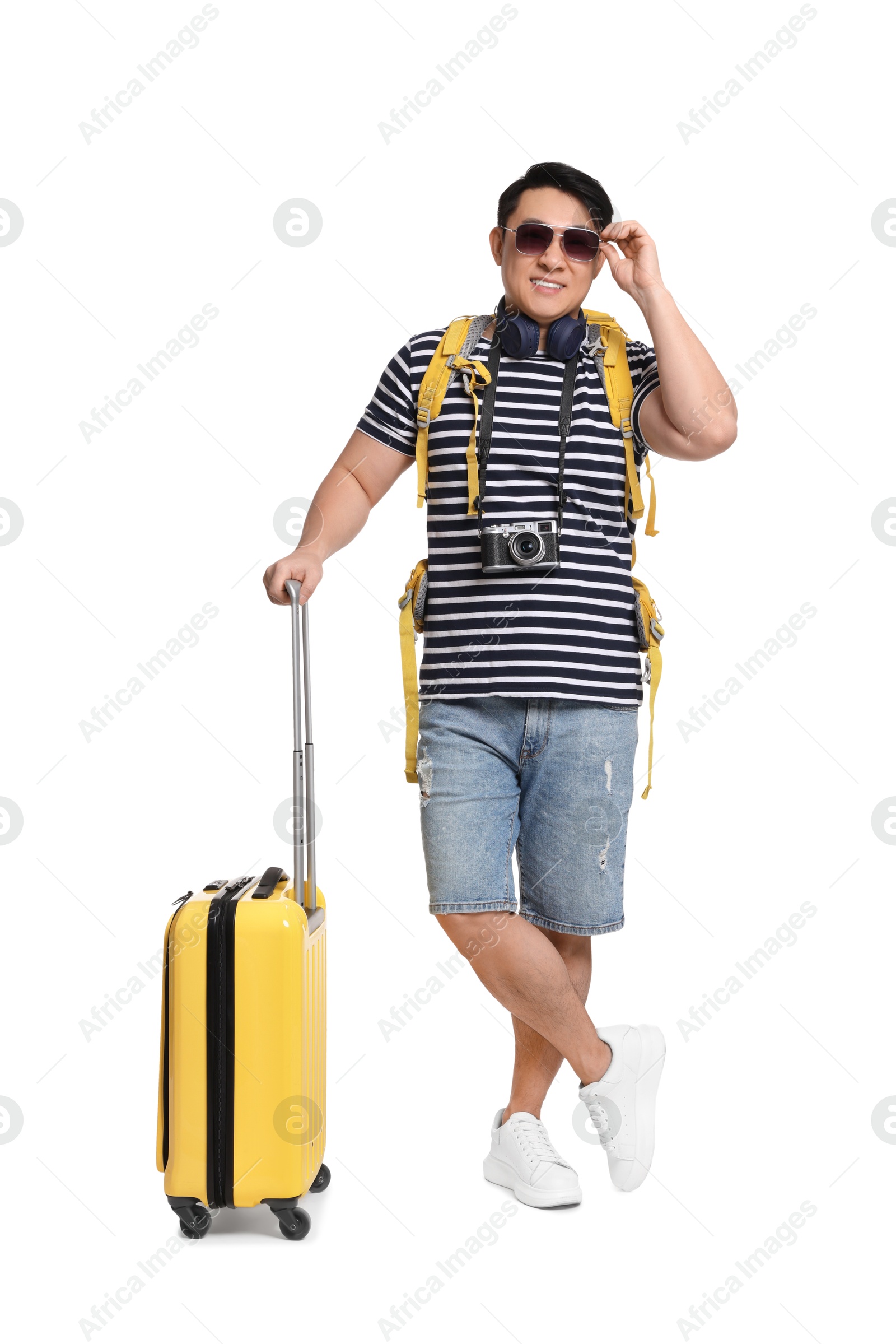 Photo of Happy traveller with suitcase on white background