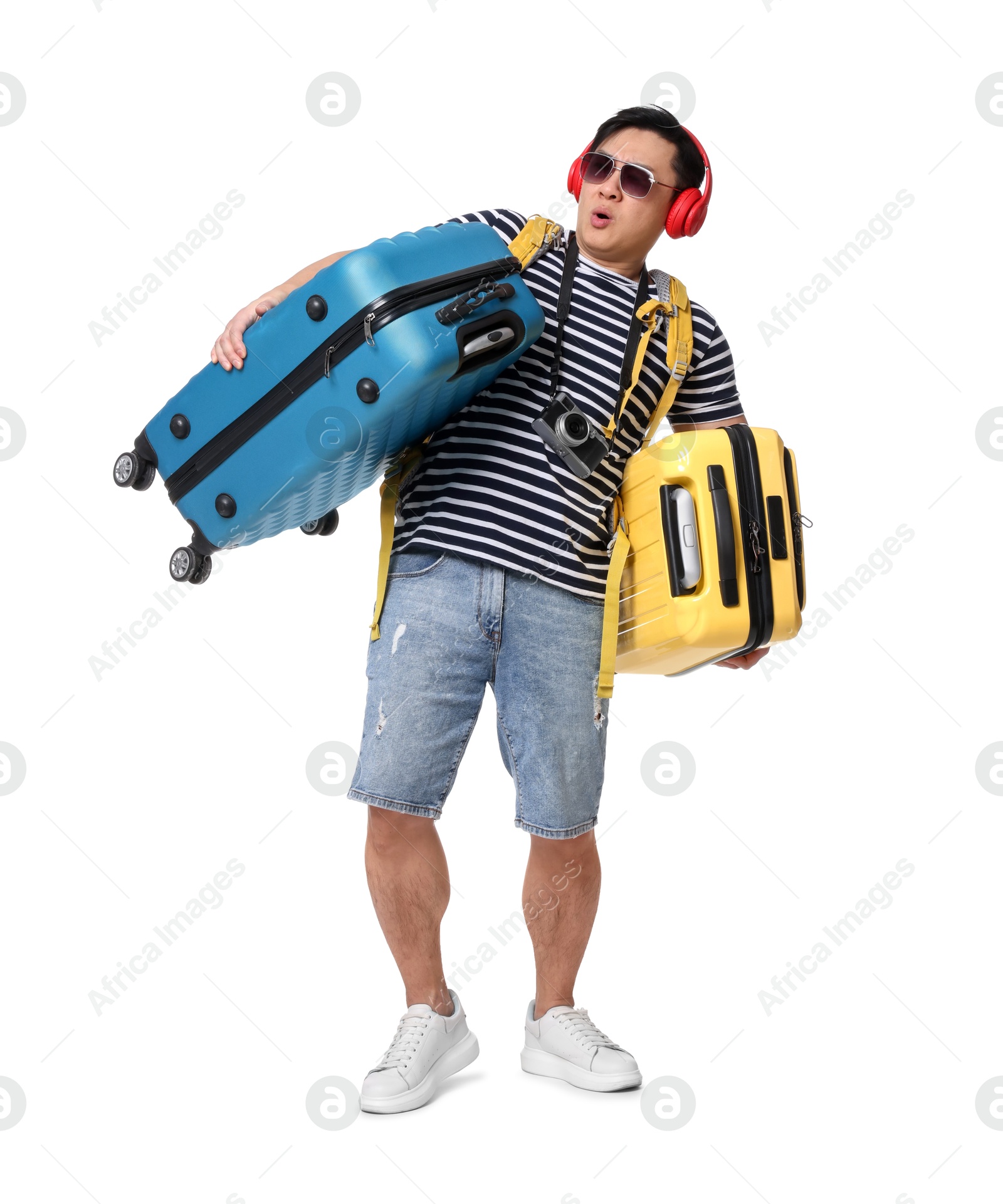 Photo of Traveller carrying heavy suitcases on white background